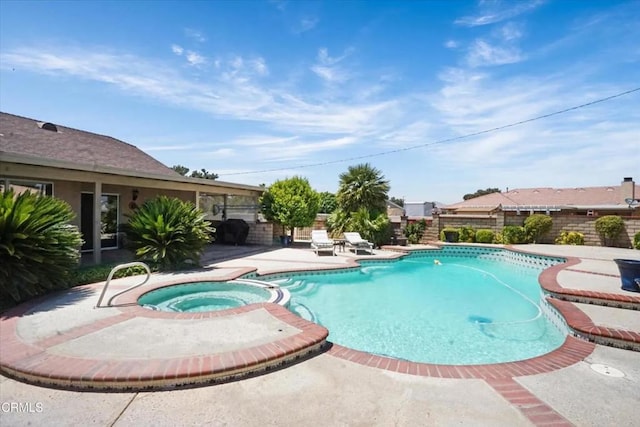 view of swimming pool with a patio area, a fenced backyard, and a pool with connected hot tub