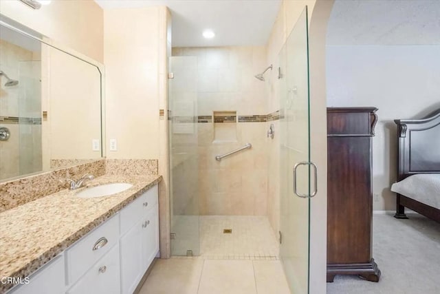 bathroom featuring a stall shower, vanity, and tile patterned floors