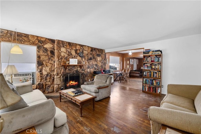 living area with a fireplace and wood finished floors