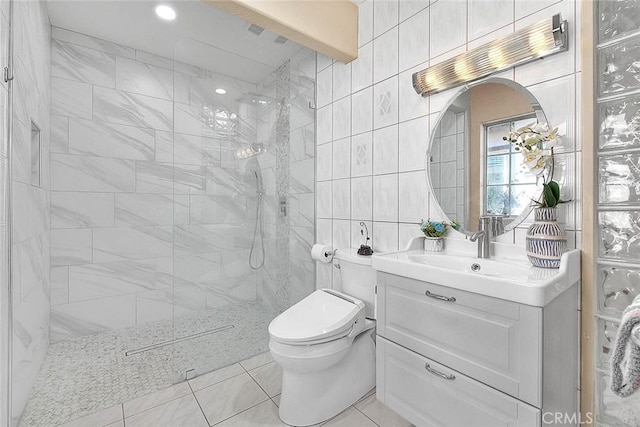 full bathroom featuring toilet, walk in shower, tile walls, and vanity