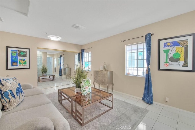 living room with visible vents, baseboards, and tile patterned floors