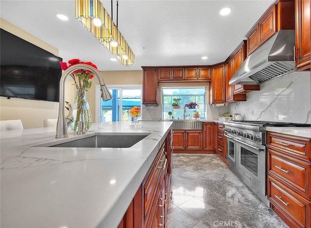 kitchen with range with two ovens, a sink, under cabinet range hood, and tasteful backsplash