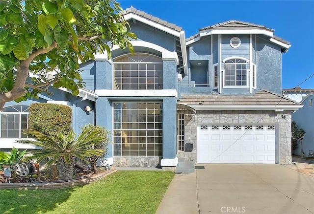 view of front of property featuring stone siding, concrete driveway, a tiled roof, and an attached garage