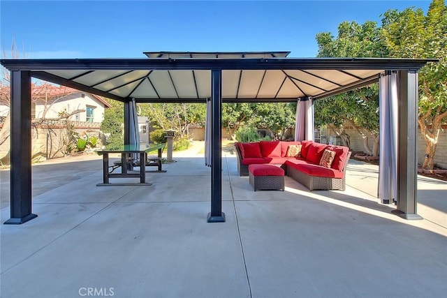 view of patio / terrace with fence, an outdoor living space, and a gazebo