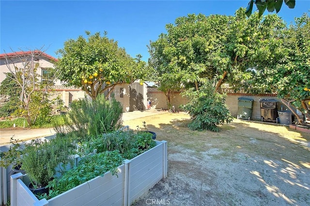 view of yard featuring a garden and a fenced backyard