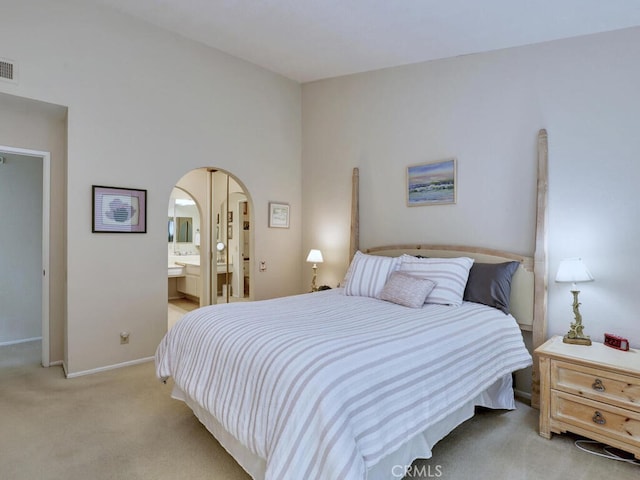 27740 Via Sarasate, Mission Viejo, CA 92692 - bedroom with light carpet, arched walkways, and ensuite bath