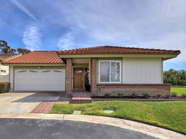 27740 Via Sarasate, Mission Viejo, CA 92692 - view of front facade with driveway, a garage, a front yard, and a tiled roof
