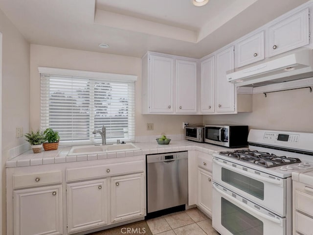 27740 Via Sarasate, Mission Viejo, CA 92692 - kitchen featuring stainless steel appliances, under cabinet range hood, white cabinets, a raised ceiling, and tile counters