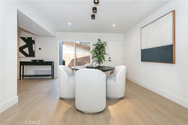 dining area with baseboards, recessed lighting, and light wood-style floors