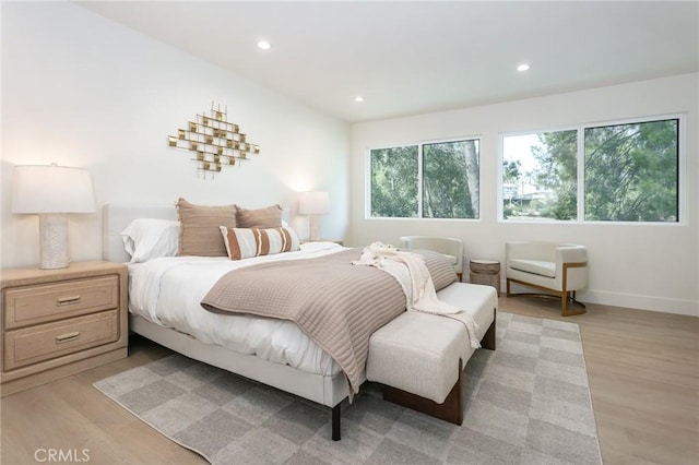 bedroom with baseboards, recessed lighting, and light wood-style floors