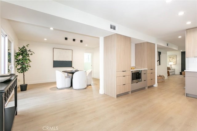 kitchen featuring recessed lighting, visible vents, light wood-style flooring, and modern cabinets