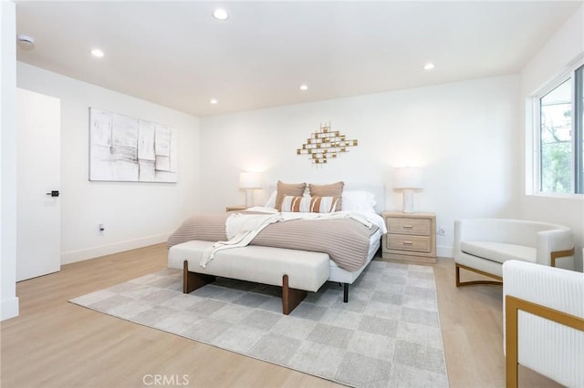 bedroom featuring baseboards, light wood-style flooring, and recessed lighting