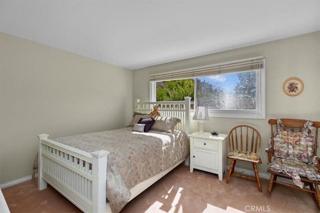 carpeted bedroom with baseboards