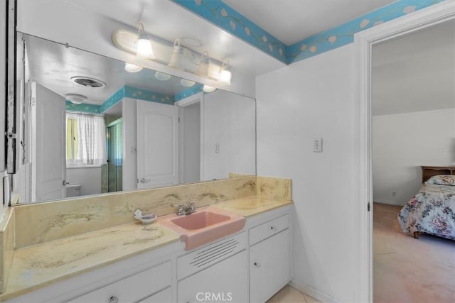 ensuite bathroom with a stall shower, ensuite bath, vanity, and baseboards