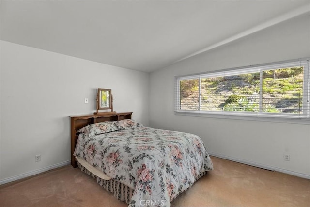 bedroom featuring lofted ceiling, carpet, and baseboards