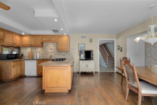 kitchen with visible vents, dishwasher, a kitchen island, dark wood-type flooring, and black microwave