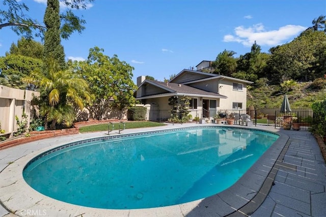 view of pool with a patio, a fenced backyard, and a fenced in pool