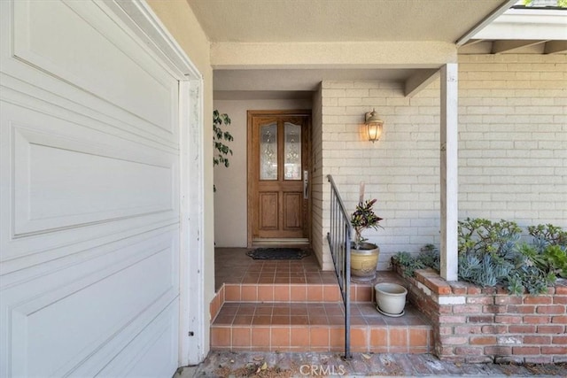 doorway to property with brick siding