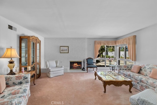 carpeted living room featuring a fireplace