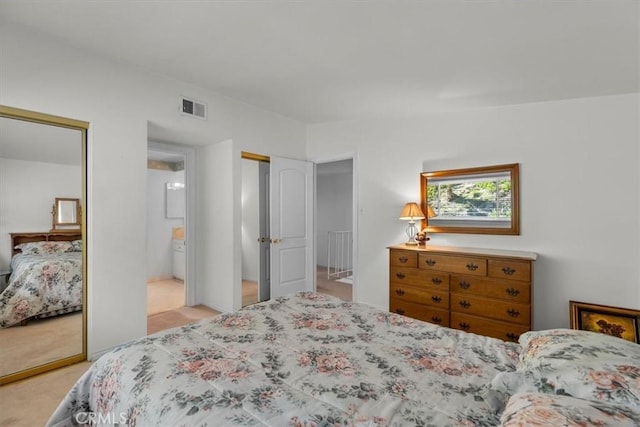 bedroom featuring carpet, visible vents, and multiple closets