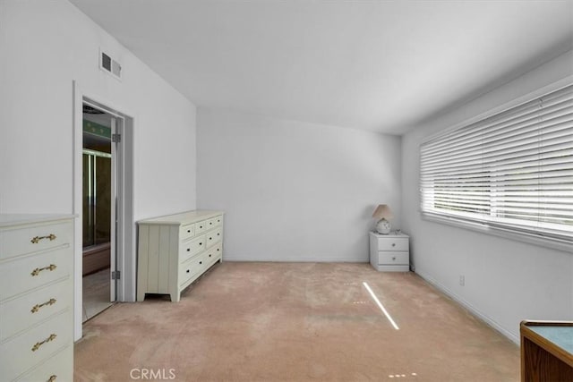 unfurnished bedroom featuring visible vents, light carpet, and baseboards