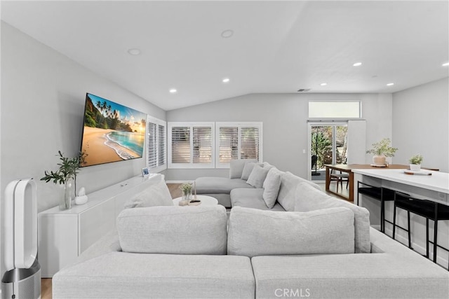 living room with vaulted ceiling, wood finished floors, recessed lighting, and visible vents