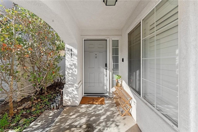 property entrance with stucco siding