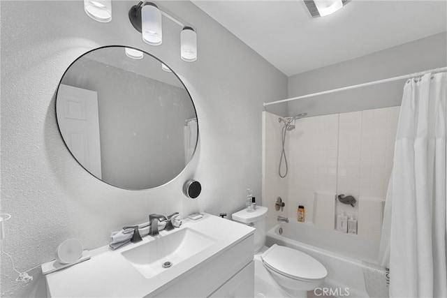 bathroom with visible vents, vanity, shower / tub combo, and toilet