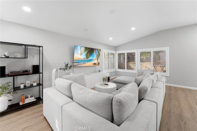 living room featuring vaulted ceiling, recessed lighting, baseboards, and wood finished floors