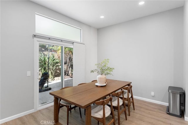 dining room with recessed lighting, light wood-type flooring, and baseboards