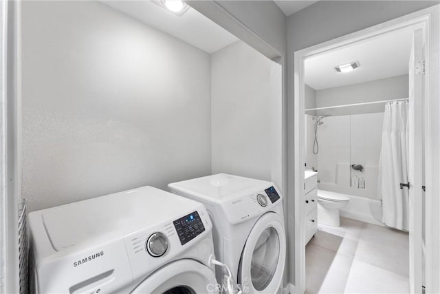 laundry room featuring laundry area, visible vents, and washer and clothes dryer