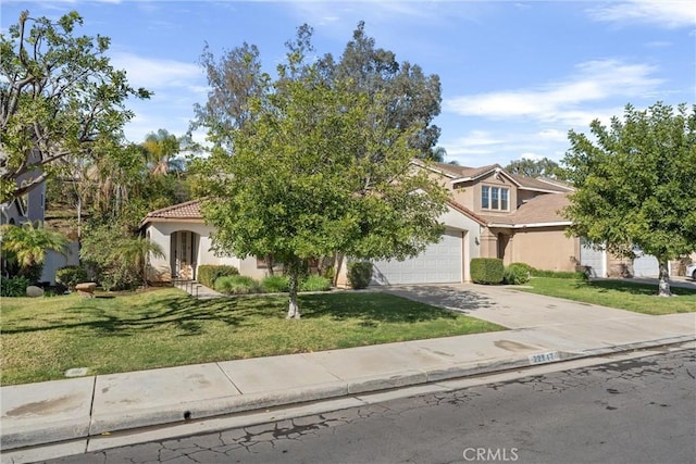 obstructed view of property with stucco siding, a front lawn, and driveway