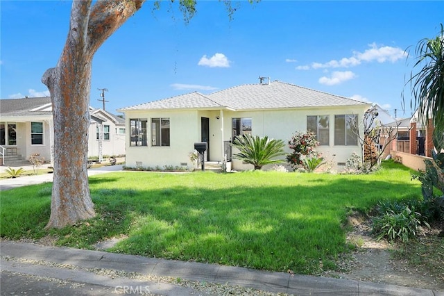 view of front of property with crawl space, roof with shingles, a front lawn, and stucco siding