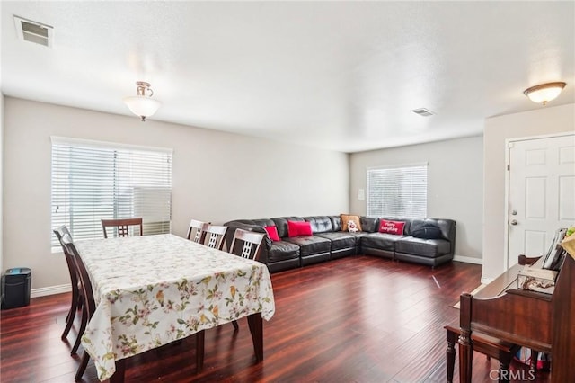 dining space featuring baseboards, visible vents, and dark wood-style flooring