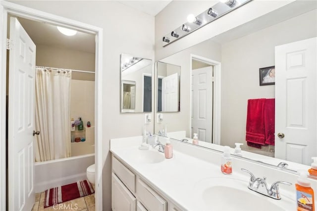 bathroom featuring double vanity, shower / bath combo, a sink, and tile patterned floors