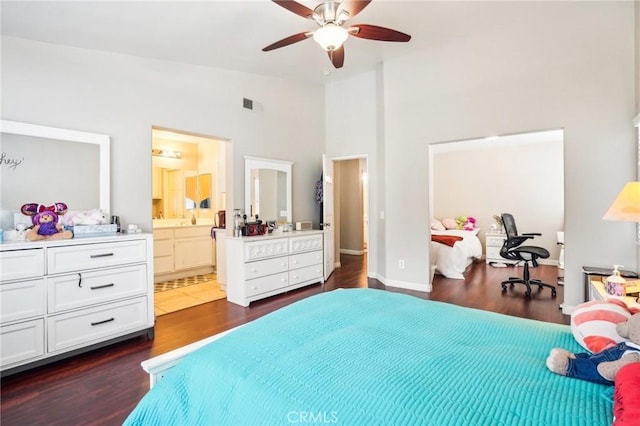 bedroom featuring visible vents, dark wood-type flooring, a ceiling fan, connected bathroom, and high vaulted ceiling