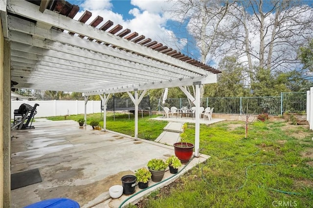 view of patio featuring a trampoline, a fenced backyard, and a pergola