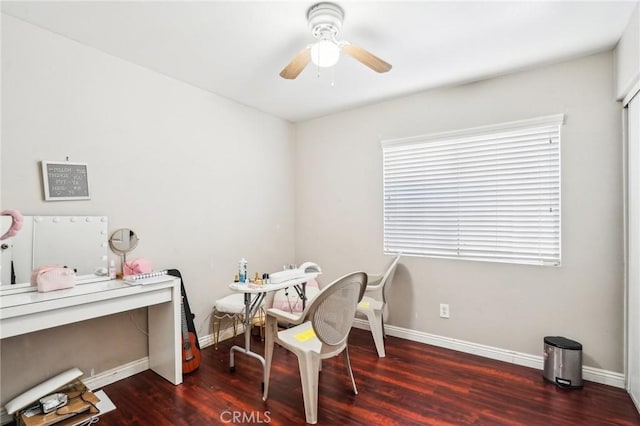 home office with a ceiling fan, baseboards, and wood finished floors