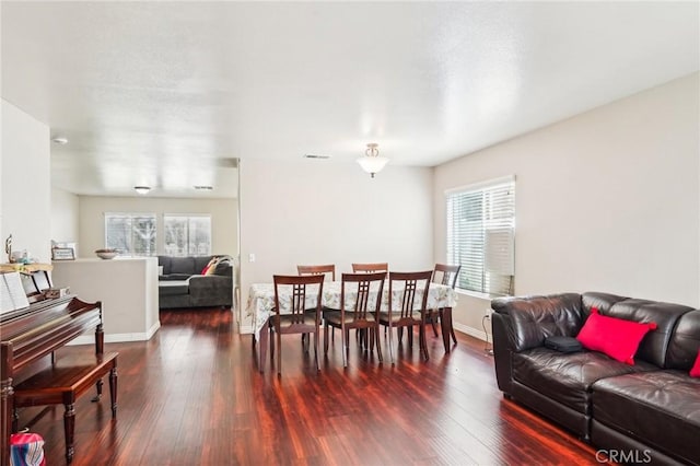 dining area featuring a wealth of natural light, visible vents, and wood finished floors