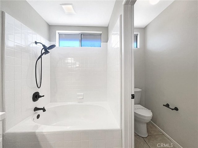 bathroom with shower / bathing tub combination, toilet, and tile patterned floors