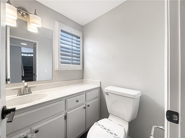 half bath featuring toilet and vanity