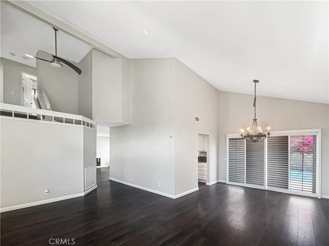 empty room featuring high vaulted ceiling, ceiling fan with notable chandelier, visible vents, baseboards, and dark wood finished floors