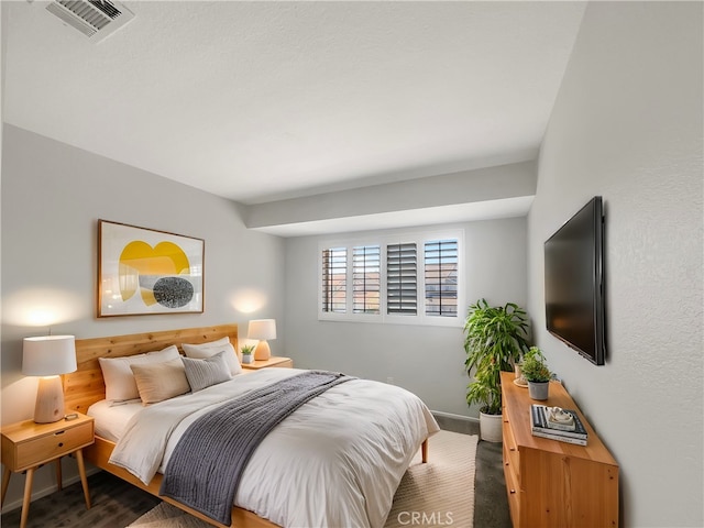 bedroom featuring visible vents and baseboards