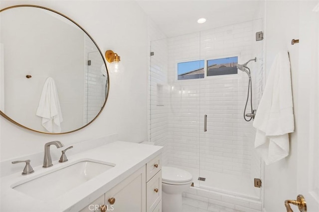 bathroom with recessed lighting, a stall shower, toilet, and vanity