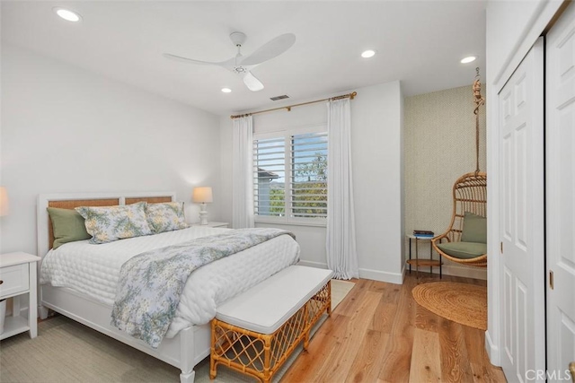 bedroom with a ceiling fan, visible vents, baseboards, recessed lighting, and light wood-type flooring