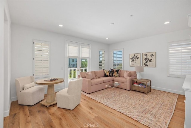 living area with recessed lighting, baseboards, and wood finished floors