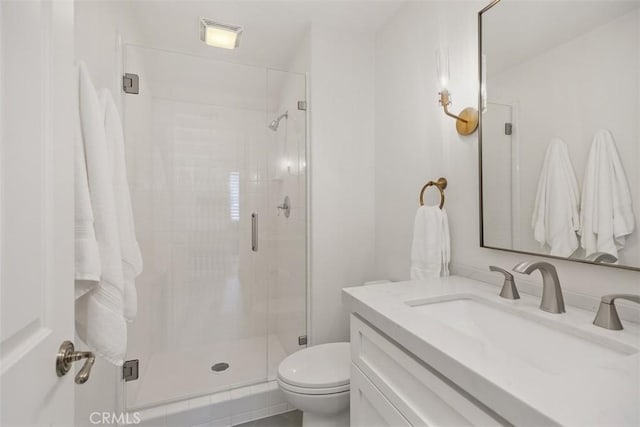 full bathroom with vanity, toilet, and a shower stall