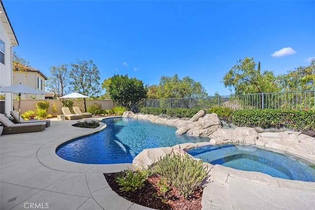 view of pool with a patio area, a fenced in pool, an in ground hot tub, and a fenced backyard