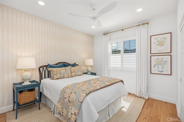 bedroom with light wood finished floors, recessed lighting, baseboards, and ceiling fan