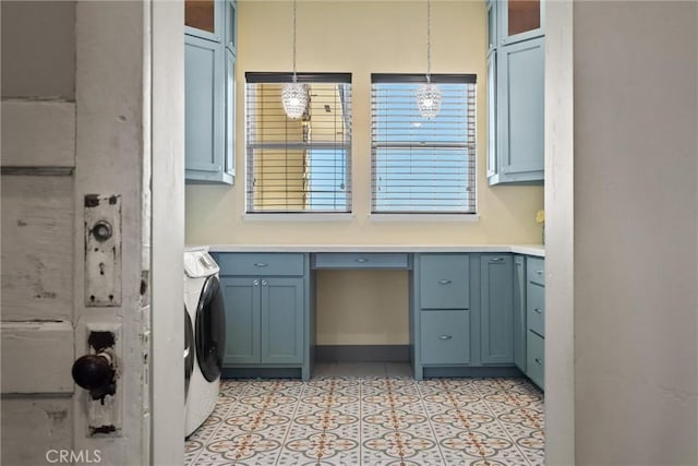 laundry area with light tile patterned floors, washer and clothes dryer, and cabinet space